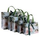 Bolsa de presente de papelão borboleta para uso em festas com alças rebitadas