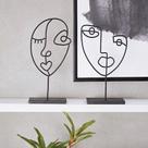 Escultura face em metal
