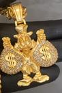 Pinjente dourado e cravejado tio patinhas