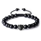Pulseira de obsidiana preta com cabeça de pantera e olhos verdes