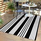 Tapete de exterior LEEVAN preto e branco listrado 120x180cm de algodão