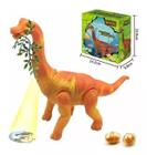 Dinossauro Anda Bota Ovo Som Luz Movimento Projetor Laranja Com folha - DM TOYS