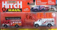 *Embalagem danificada* Matchbox Hitch &amp Haul - MBX Ambulance / Hazard Squad