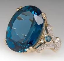 Anel com pedra grande azul e micro zirconias laterais