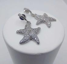 Brinco concha cravejado com micro zircônia banhado a rhodium