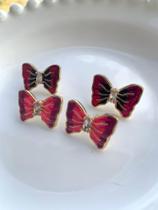 Brincos folheados a ouro esmaltado modelo gravata borboleta