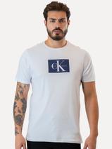 Camiseta Calvin Klein Jeans Masculina Issue New Logo Dark Block Branca Camiseta Calvin Klein Jeans Masculina Issue New Logo Dark Block Branca