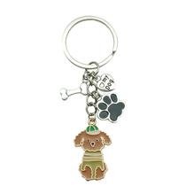 Chaveiro Creative Dog com chapéu, estampa de pata e pingente ósseo Chaveiro Creative Dog com chapéu, estampa de pata e pingente ósseo