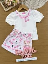 Conjunto Infantil Cinti Verão com Shorts Saia Rosa e Blusa Branca Lacinhos