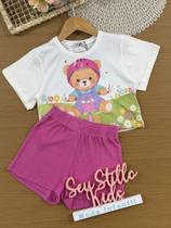 Conjunto Infantil Kukiê com Shorts Rosa e Blusa Manga Curta Ursinha Ciclista Conjunto Infantil Kukiê com Shorts Rosa e Blusa Manga Curta Ursinha Ciclista