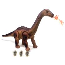 Dinossauro Anda, Bota Ovo e projeta imagem.