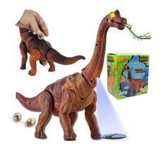 Dinossauro Anda Bota Ovo Som Luz E Movimento Projetor Animal - DM TOYS