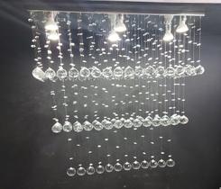 Lustre de cristal para sala de jantar/estar com 90cm de altura, base de inox espelhado com 70x20cm Lustre de cristal para sala de jantar/estar com 90cm de altura, base de inox espelhado com 70x20cm