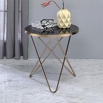 Mesa lateral redonda Yardlio Valora con base metálica negra en forma de V y superficie de vidrio color champán