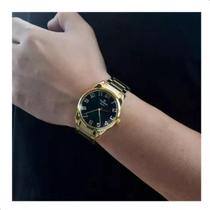 Relogio champion masculino dourado grande visor preto cn27652u numeros