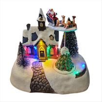 Vila Natalina LED Cenário Movimento Noel Com Rena Pilha 20cm Vila Natalina LED Cenário Movimento Noel Com Rena Pilha 20cm