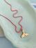 Colar rosa, Pingente ouro
