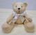 Urso bege com laço de cetim branco