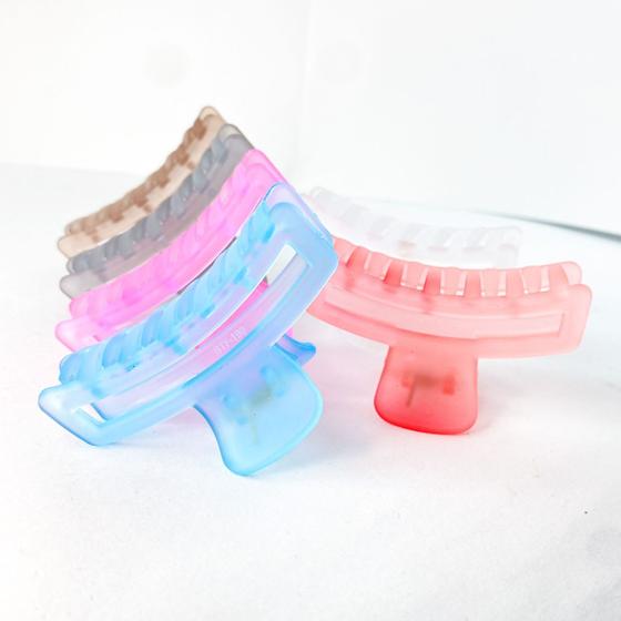 Imagem de Kit 12 unidades de Presilhas garra para cabelo formato torcido recorte vazado transparente lisa