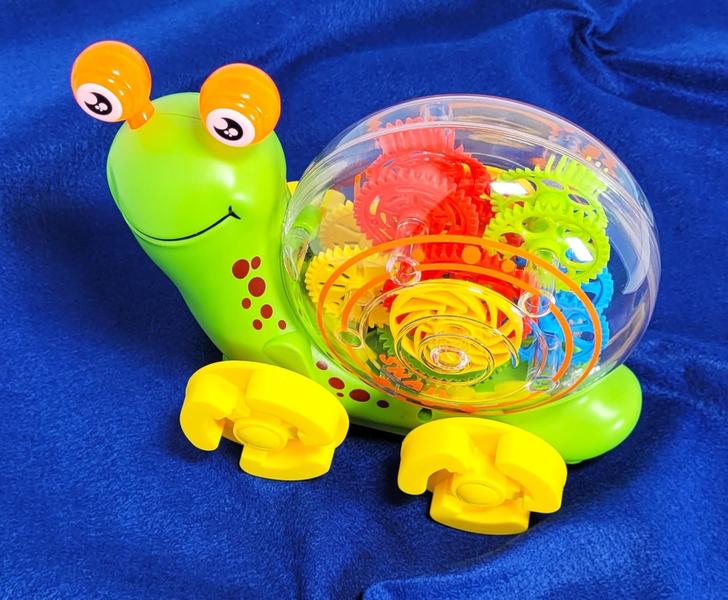 Imagem de Bebe Musical Caracol Braskit Brinquedo Bate e Gira com Musica Luzes Projetor e Engrenagens