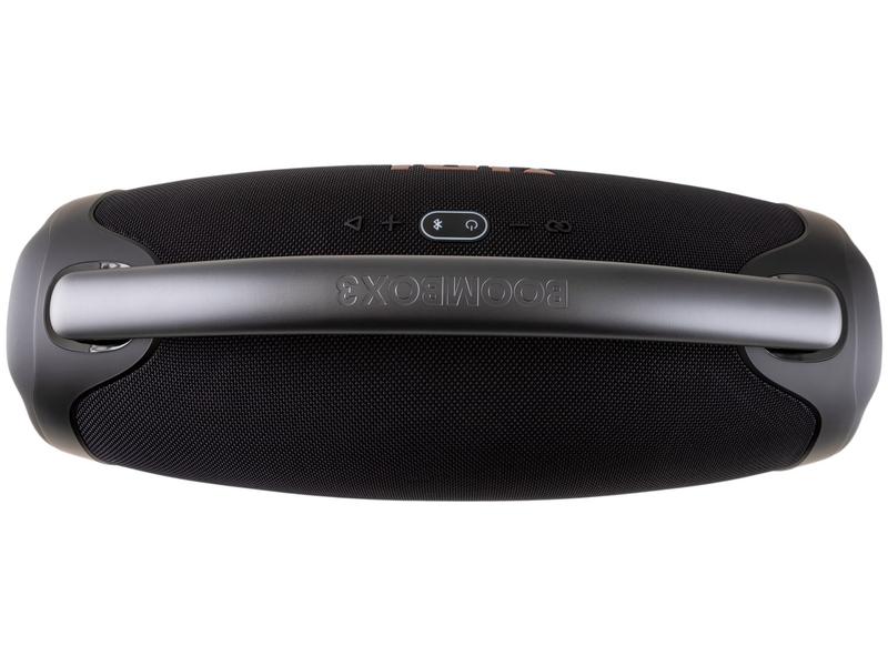 Uma JBL Boombox 3 cercada por um grupo de pessoas, cada uma segurando a caixa de som e expressando suas opiniões e análises através de gestos e expressões faciais.