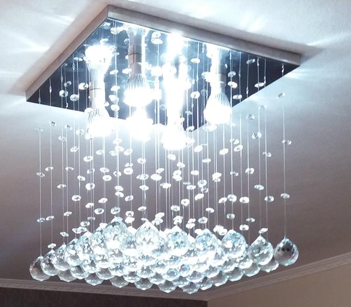 Imagem de Lustre de cristal para sala de jantar com 50 cm de altura base de inox polido de 30x30cm