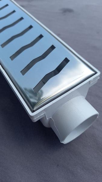 Ralo Linear 6x50 modelo Grelha Inox Polida Desenho S Coletor Branco - Ficone Reis Imagem de Ralo Linear 6x50 modelo Grelha Inox Polida Desenho S Coletor Branco - Ficone Reis