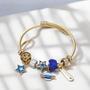 Imagem de Bracelete Pulseira Dourada Ajustável Com 7 Berloques