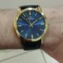 Imagem de Relogio Champion Masculino dourado pulseira de couro fundo azul  CN20702S